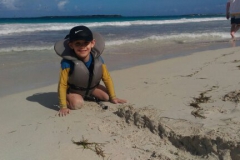 Eli is making a very complex sand construction.